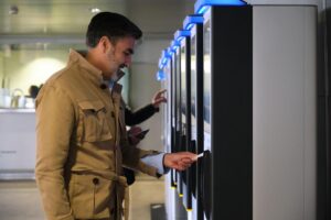 buying-train-ticket-at-self-service-kiosk-in-railway-station